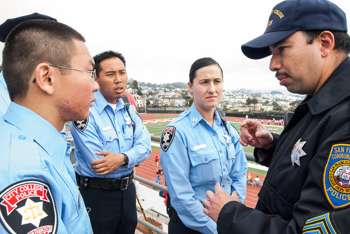 A group of  City College student police officers Bryan Louie, 21, Jason Ho, 25 and Nicole Scherle, 25, listen to San Francisco Community College District police Sgt. Carlos Gaytan brief them on the duties before a football game at Rams Stadium on Ocean campus Nov. 2, 2013. Photo by Ekevara Kitpowsong/The Guardsman