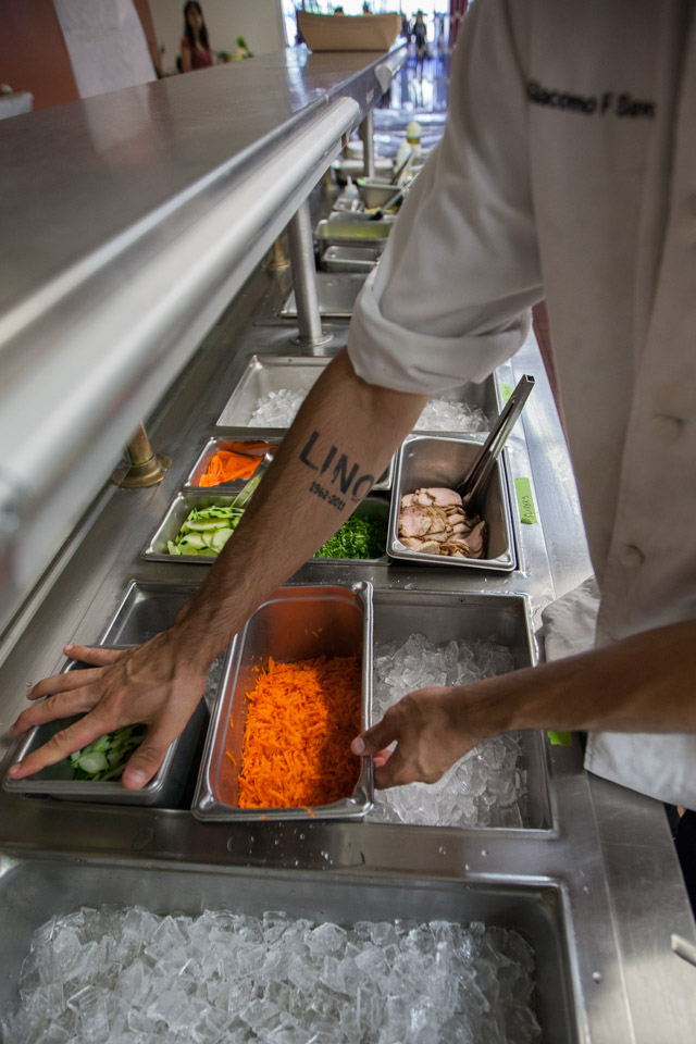 Giacomo Savoia, a third semester Culinary Arts and Hospitality Studies student, prepares the sandwich station for the grand opening of Radius 99 on Wednesday, Aug. 27, 2014 at City College’s Ocean campus. (Photo by Nathaniel Y. Downes)