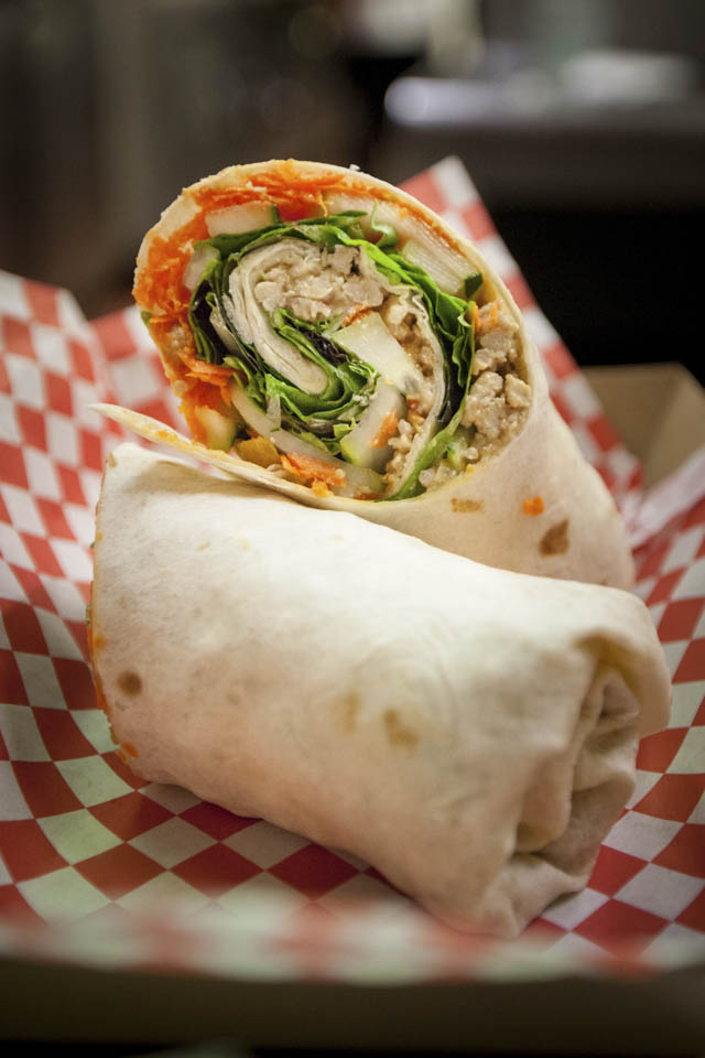 An Asian turkey wrap with cucumbers, mint, lettuce and peanut is one of the items on the menu for the grand opening of the new student run restaurant at Smith Hall, Radius 99 on Wednesday, Aug. 27, 2014. (Photo by Nathaniel Y. Downes)