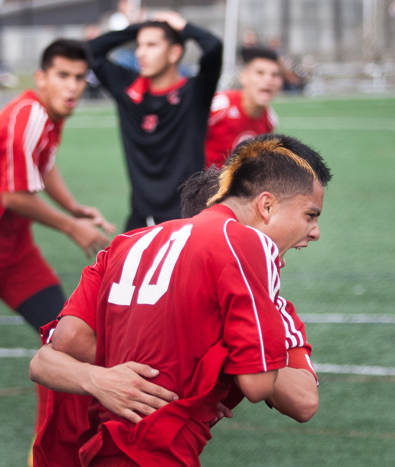 City College Rams sophomore center Andy Altamirano (10) celebrates his game tying goal with a teammate, Saturday, Nov. 22, 2014, during a CCCAA men's soccer playoff game against Las Positas College Hawks at Ram Stadium, San Francisco, Calif. (Santiago Mejia/The Guardsman)