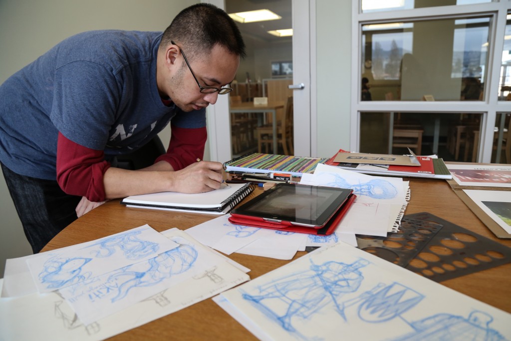 Illustrator Anthony Mata sketches original artwork at the City College Mission Center Library on Tuesday, March 10. (Photo by Natasha Dangond)