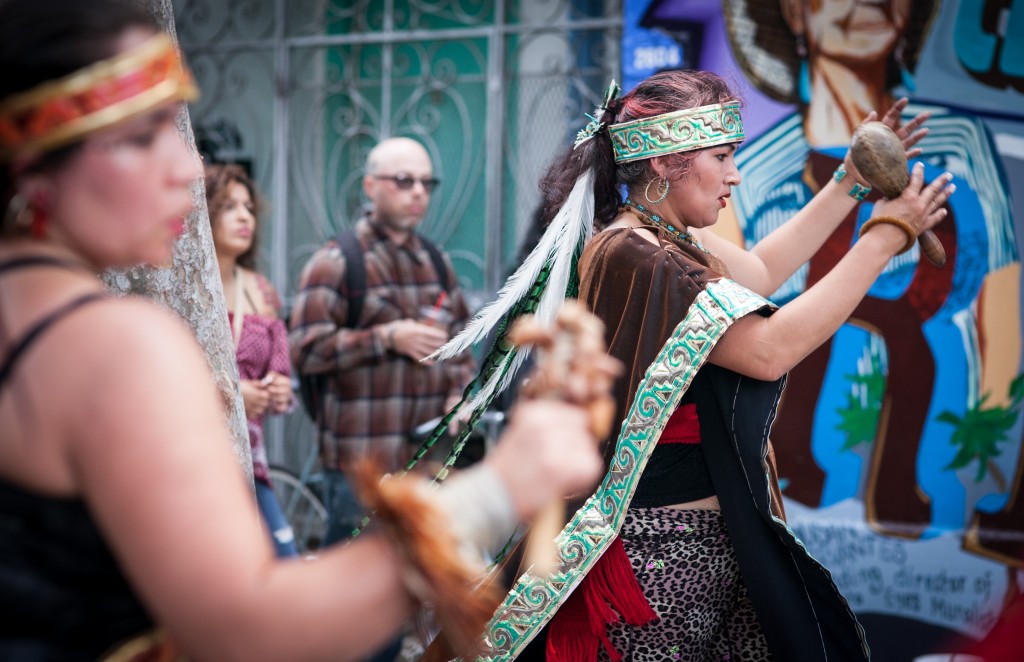 Spiritual traditional dancer Sandra Sandoval of Xiuhcoatl Danza Azteca performs the dance to celebrate the opening of the mural at the corner of 24th and Folsom streets in the Mission District on Saturday, Aug. 8, 2015. (Photo by Ekevara Kitpowsong/TheGuardsman)