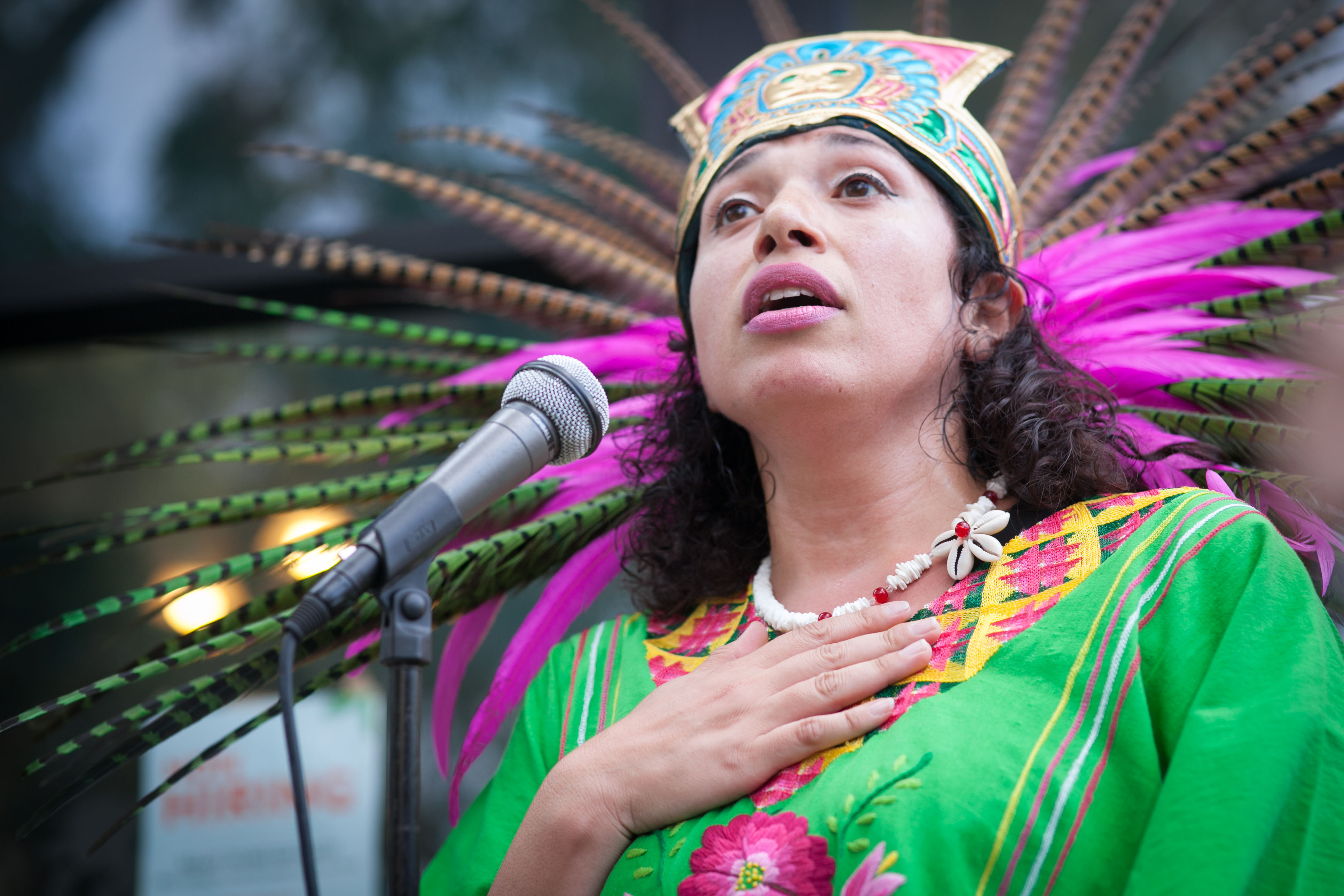 Traditional dancer Blanca Rodriguez of Xiuhcoatl Danza Azteca speaks to the crowd during a celebration of the mural project’s opening, at the corner of 24th and Folsom streets on Saturday, Aug. 8, 2015. (Photo by Ekevara Kitpowsong/The Guardsman)