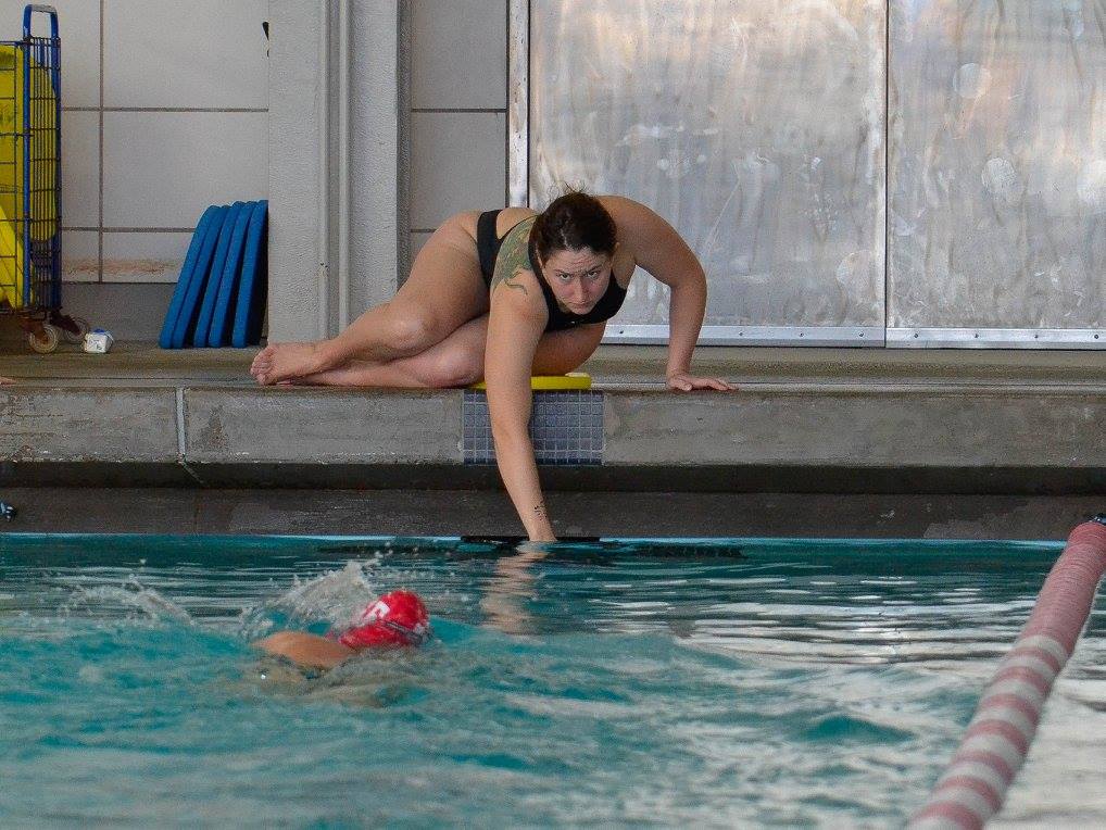 City College swim team captain Liz Thompson encourages her teammate during team practice at the Wellness Center. Feb. 2016. (Photo by Cody Davis/Special to The Guardsman)