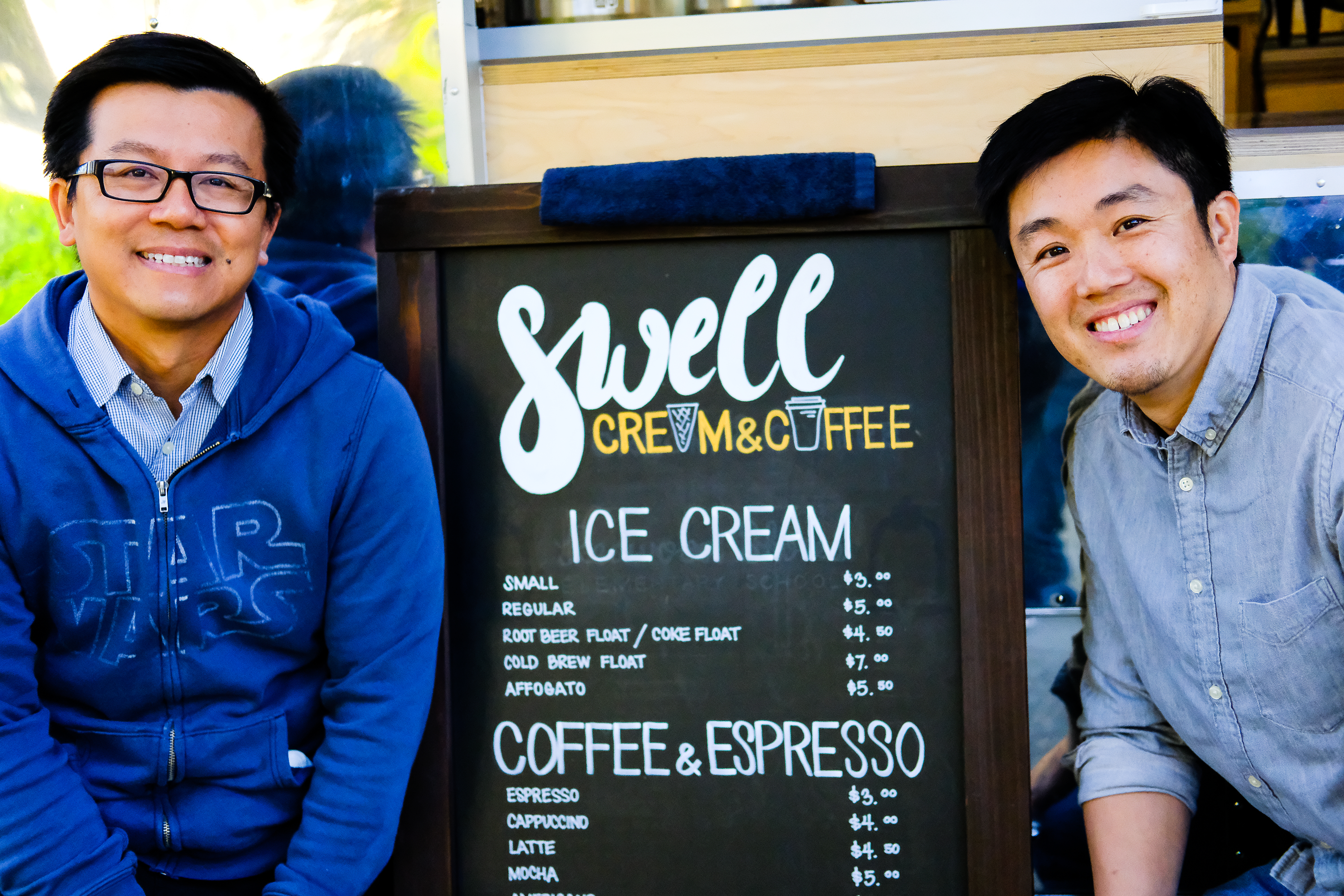 Owners and business partners Ta Ratana (left) and Benson Chiu (right) with menu in front of Swell Cream & Coffee. Picture by Otto Pippenger, April 17, 2017. 