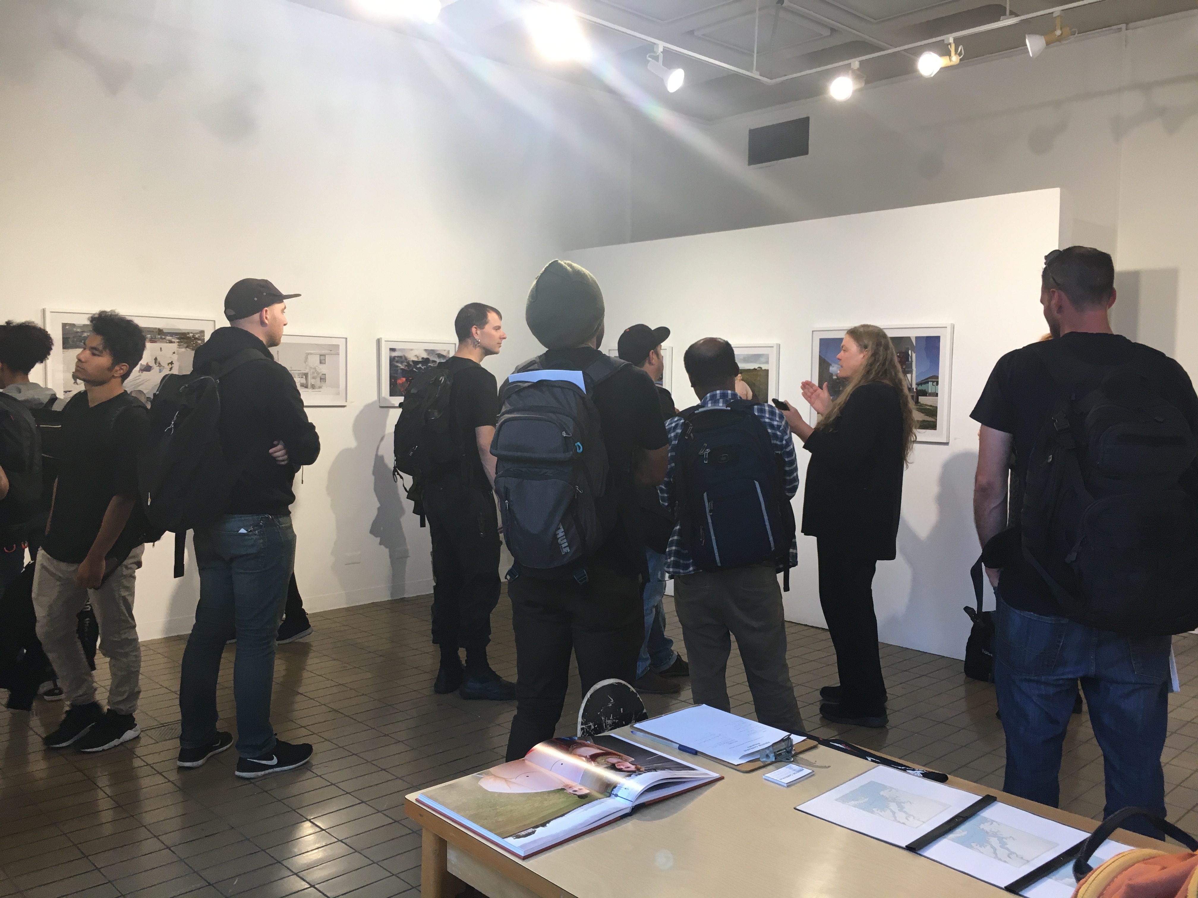 CCSF professor Judith Lynn Walgren discusses the meaning of aperture to CCSF photography and watercolor students at Preston Gannaway’s exhibition on September 6, 2017. (Photo by Laurie Maemura)
