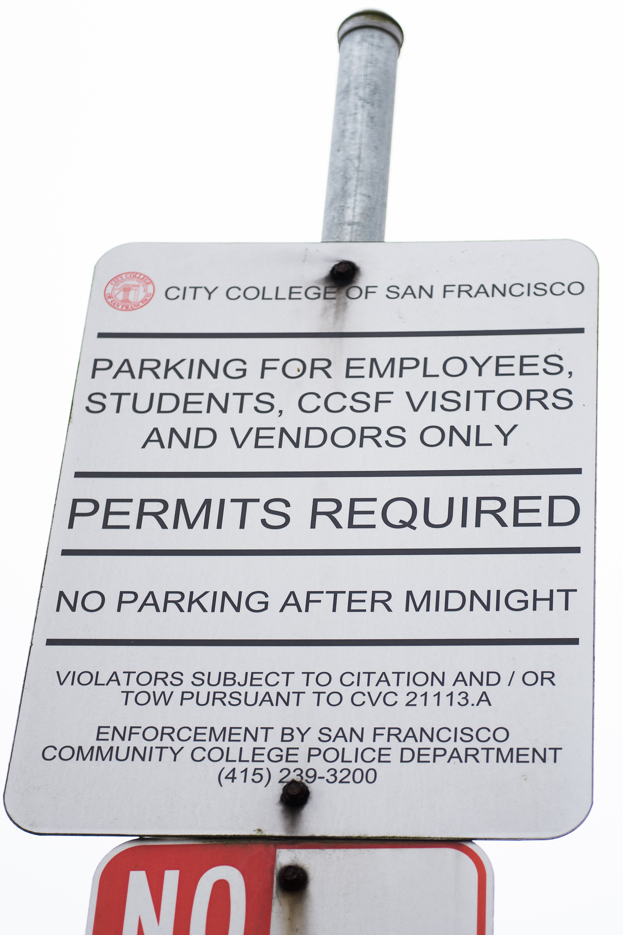 A sign looms over cars in the lower parking lot requiring permits to be purchased. Photo taken Aug 28 2017 by Otto Pippenger.