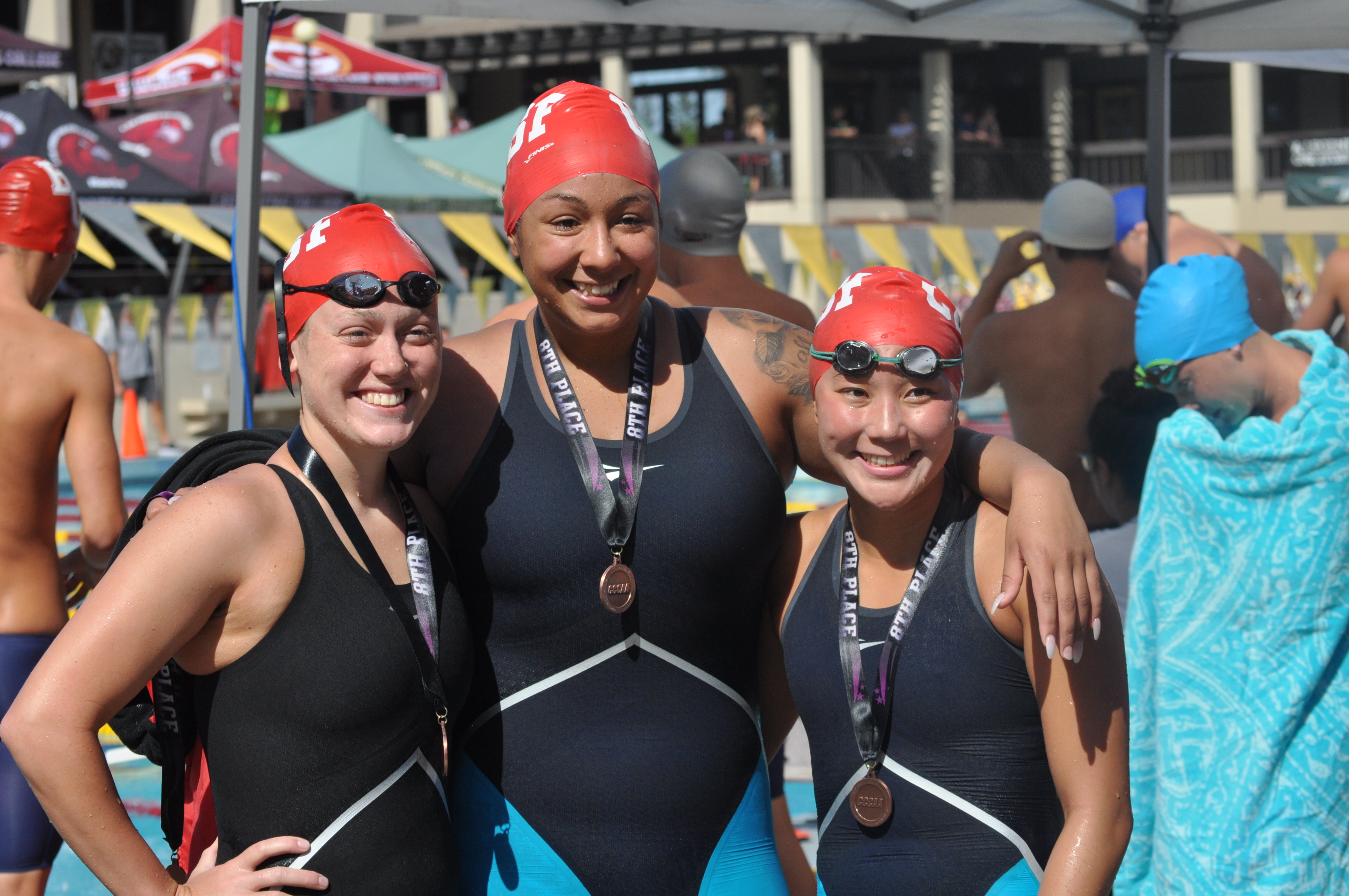 Ashley Davis, left to right, Julia Lane, and Alika Lew-Koga are all in smiles after placing 8th in 200 Yard Medley team relay at De Anza College on May 4, 2018. Photo by Peter J. Suter/The Guardsman.