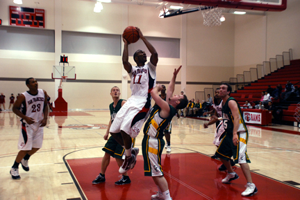 Sophomore guard Bennie Rhodes goes hard to the basket against a Cañada defender during the Rams' vicotry on Jan. 22 at the Wellness Center. RAMSEY EL-QARE / THE GUARDSMAN