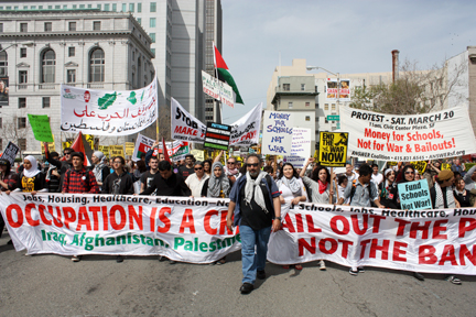 Jess Ghamman from the Free Palestine Alliance leads demonstrators back to the Civic Center during the March 20 Anti-occupation rally. ROBERT ROMANO / THE GUARDSMAN