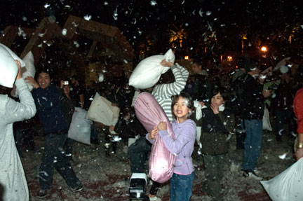A young girl clutches her pillow, in a flurry of feathers, during the Great San Francisco Pillow Fight at Justin Herman Plaza on Feb. 14. A flash-mob tradition since 2006, the pillow fight begins as the Ferry Building clock strikes 6 p.m. Hundreds attend the event, advertised through word-of-mouth, as a non-traditional way to celebrate a traditionally romantic holiday. Feathers, adrift for blocks, cling to attendees and bystanders. At 10 p.m. pillows are replaced with boom-boxes and brooms as the flash-mob clean up crew removes feathers and cotton debris from the plaza and surrounding blocks. CHLOE ASHCRAFT / THE GUARDSMAN