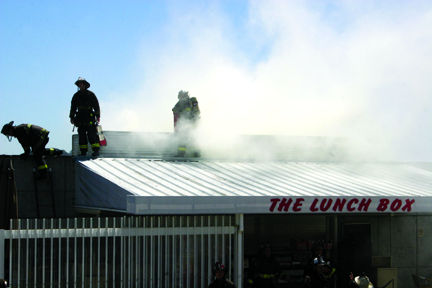 San Francisco firefighters douse a small blaze at the Ocean campus Lunch Box on May 6. ALEX EMSLIE / THE GUARDSMAN