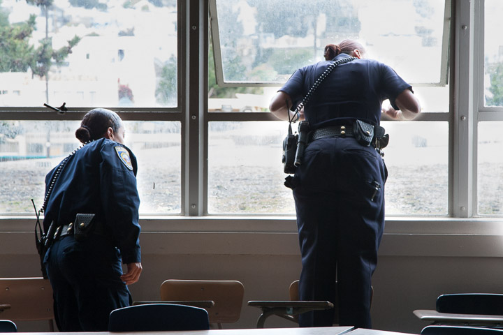 (L-R) Officers Erica McGlaston and Tiffany Green look out of the window of the Arts Extension building at Ocean campus after receiving a call that students were on top of the roof, Thursday, Feb. 27, 2014. Photo by Santiago Mejia/The Guardsman