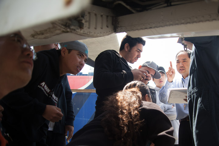 Instructor Hoi Ko, right, gives a lecture of the aircraft to his students.