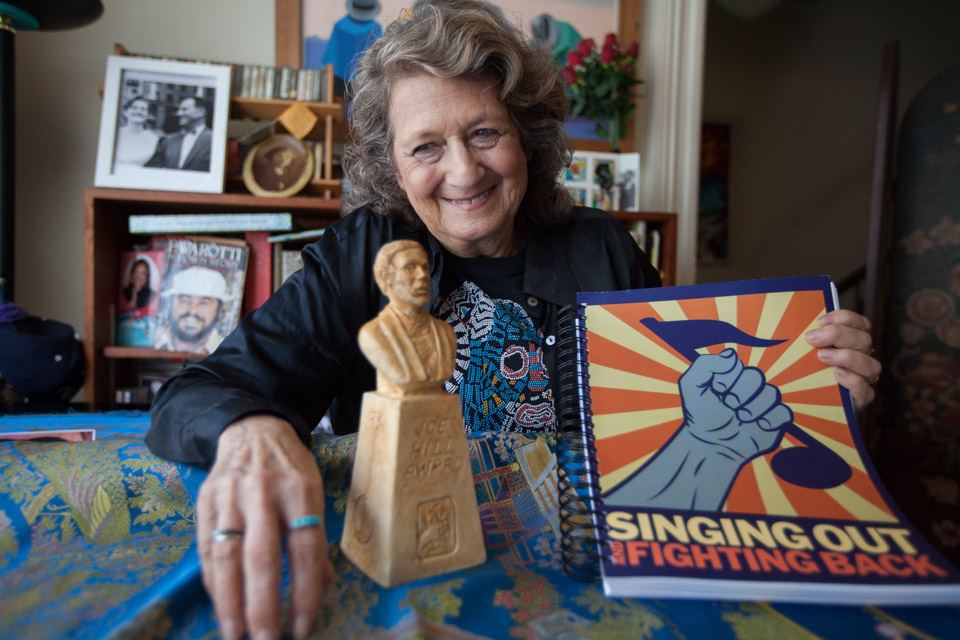 Patricia Wynne poses for a photo Aug.11with her Joe Hill Award and new book entitled "Singing Out and Fighting Back." Photo by Nathaniel Y. Downes
