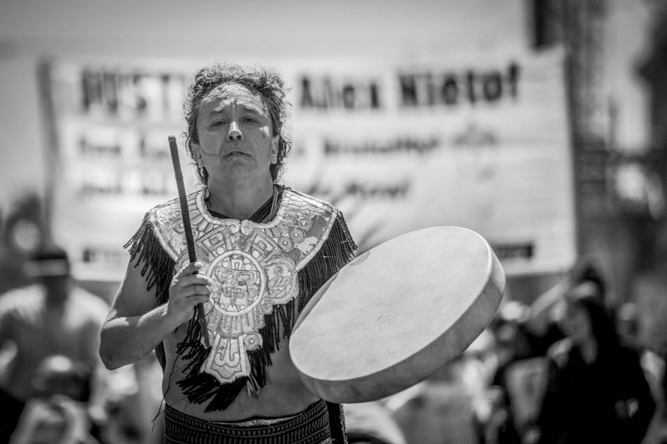 Louie Gutierrez leads the Saturday, Aug. 22 march in honor of Alejandro Nieto with his Aztec dance group Coyolxauqi down Van Ness Avenue. (Photo by Nathaniel Y. Downes) 