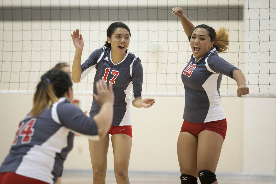 Rams Katie Kellie (17) and Brianna Caba (16) celebrate after scoring a point. (Photo by Santiago Mejia)