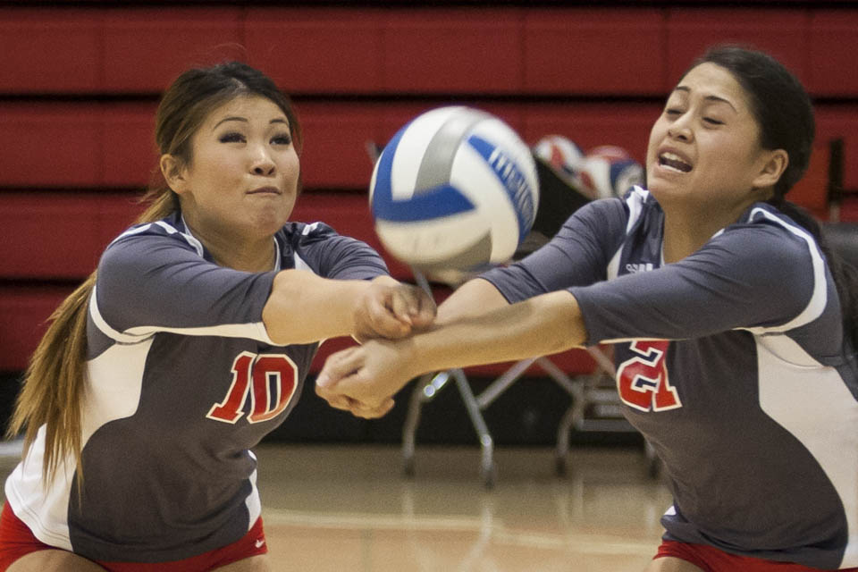 Rams Cynthia Lin (10) and Gaea Salazar (21) both dig at an incoming spike. (Photo by Santiago Mejia)