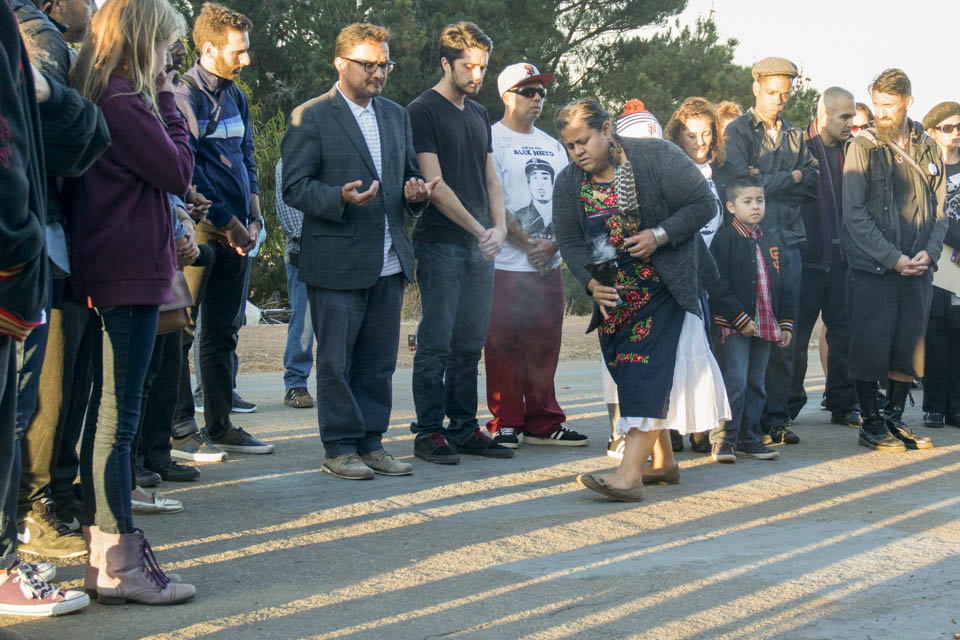 Lorena de la Rosa burns sage in an Aztec ceremony that symbolizes cleansing, purifying and protecting of the physical and spiritual bodies during the sunset vigil in honor of  Alex Nieto at the 5-month anniversary of his death in Bernal Heights Park in San Francisco on Thursday, Aug. 21, 2014. (Photo by Niko Plagakis)