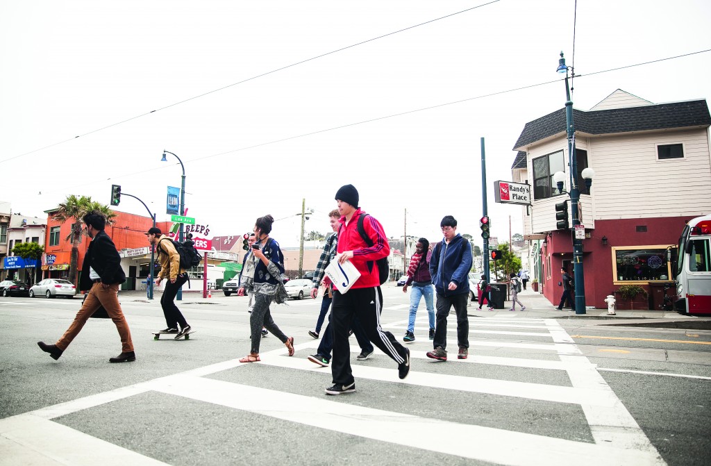 City College students cross the street on a red light after getting off the bus on Ocean and Lee avenues, Monday, May 11. (Photo by Ekevara Kitpowsong) 