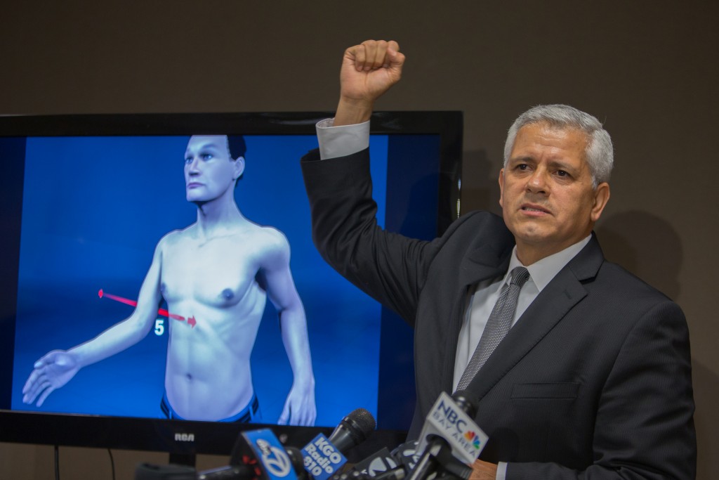 Arnaldo Casillas, Amilcar Perez-Lopez's attorney, showing crime scene and autopsy evidence at a news conference  April 25, 2015 San Francisco, CA ( photo by Khaled Sayed) 