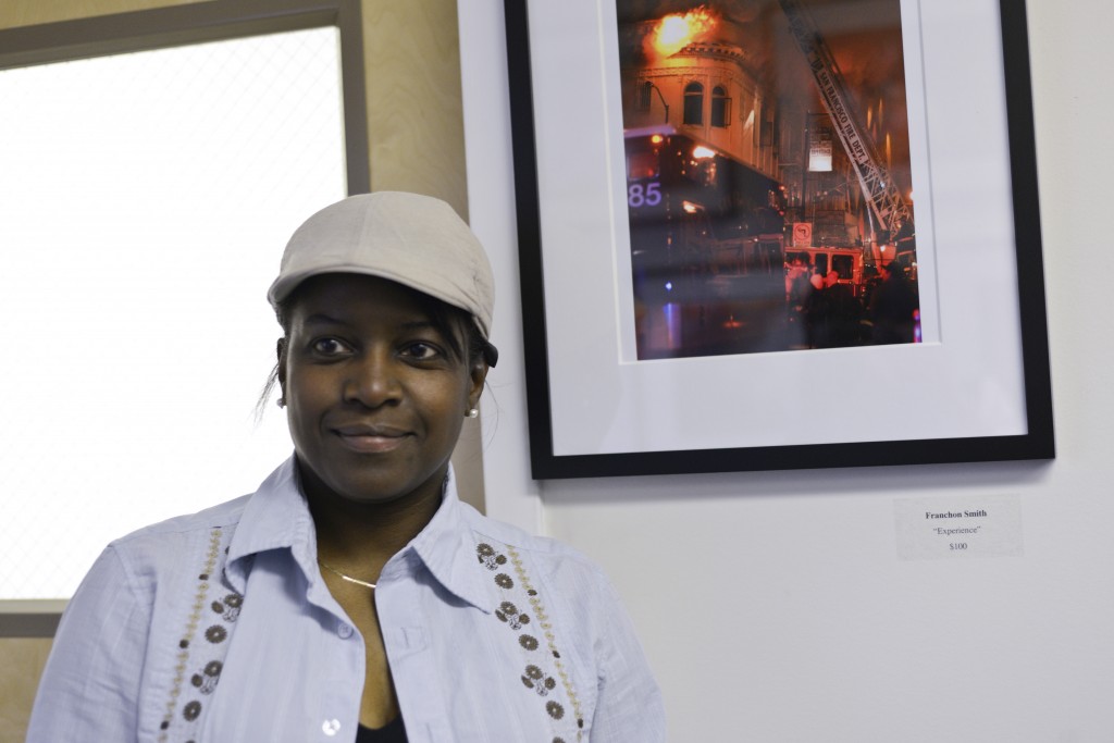 Franchon Smith is one of 11 photographers featured in the group photo exhibition. Smith’s two photographs on display were taken during a massive fire in the Mission District on Jan. 28. (Photo by Yesica Prado)