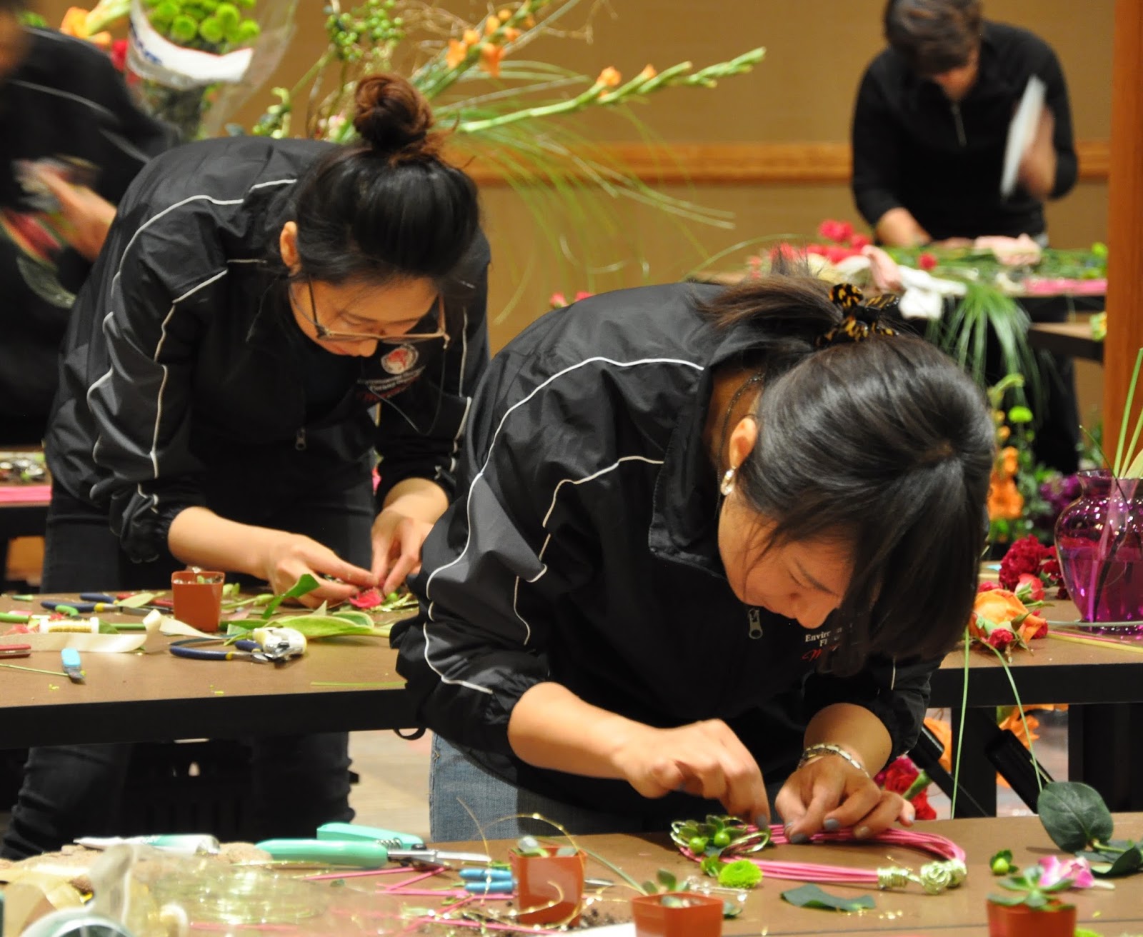 So Yeon, left, and Kyung Yun, right, creating Body Flowers Design at the Student AIFD competition in Denver. (Photo courtesy of jennytabarracci.blogspot.com)
