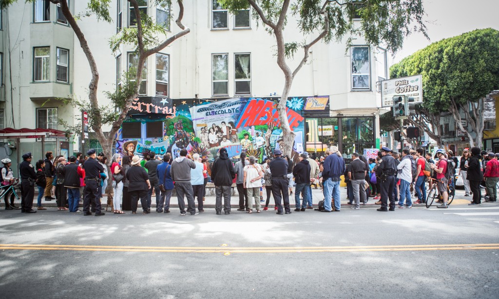 Crowds gather around the corner of 24th and Folsom streets in the Mission District on Saturday, Aug. 8 to watch the dance performance celebrating the opening of the mural titled “This Place.” (Photo by Ekevara Kitpowsong/TheGuardsman)