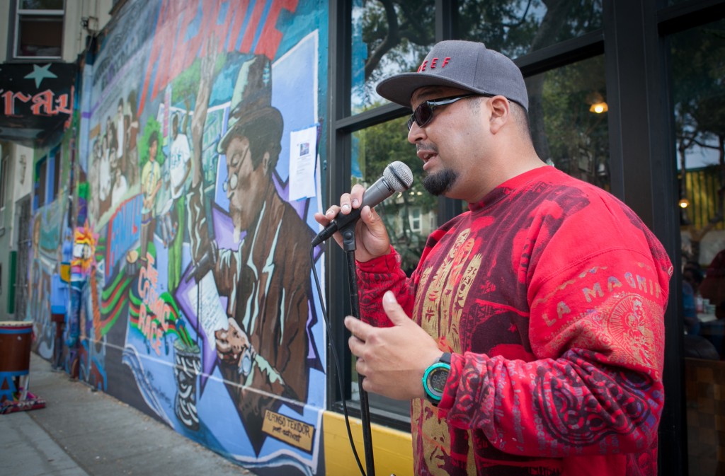 The Director of mural Fred Alvarado speaks to the crowd during the opening celebration of the mural project at the corner of 24th and Folsom streets on Saturday, Aug. 8, 2015. (Photo by Ekevara Kitpowsong/TheGuardsman)