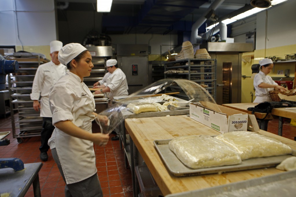  First semester culinary student Lesia Gomez pulls out cellophane to cover the pastry dough. (Photo by Franchon Smith/ The Guardsman)