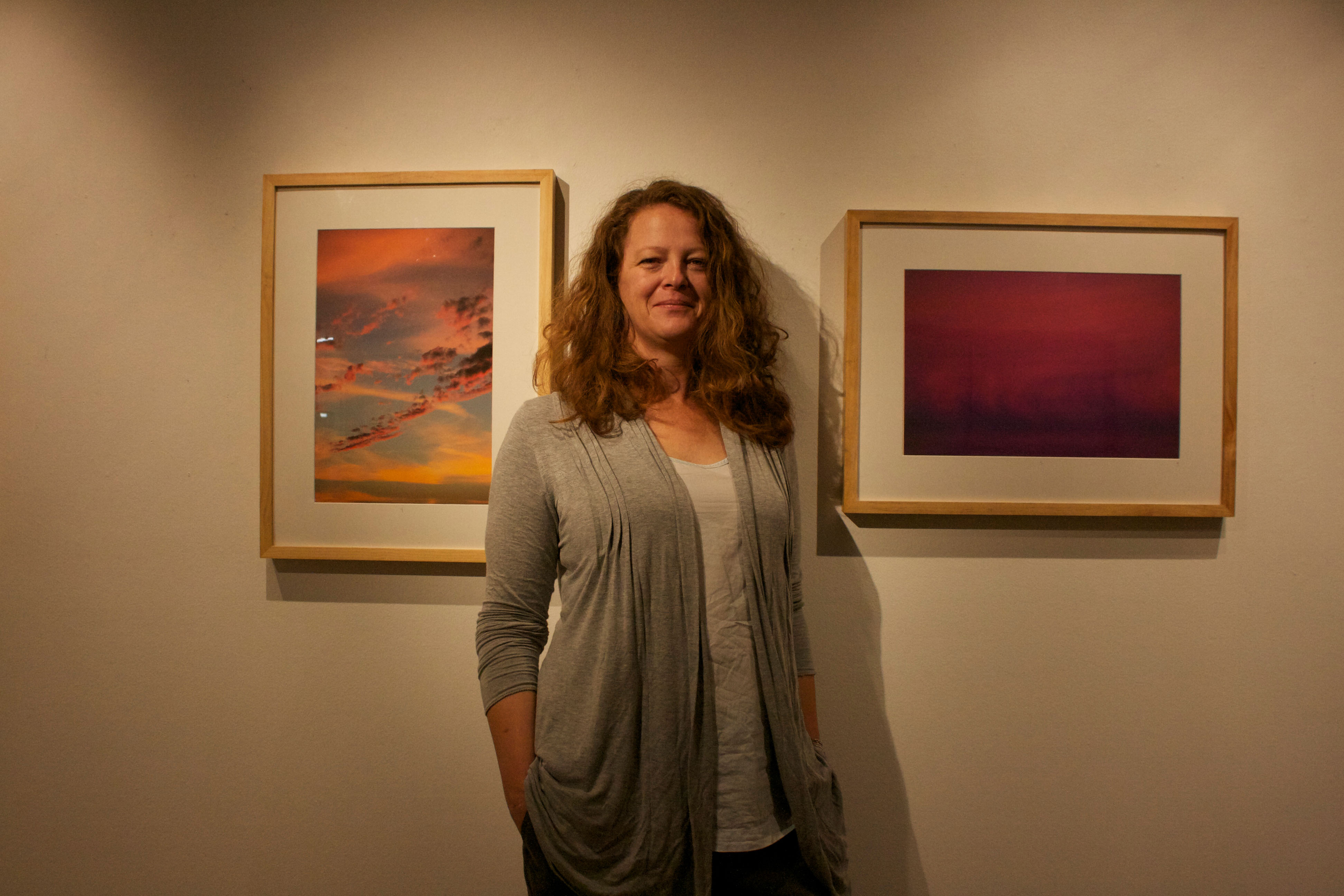 City College photography student, Adrienne Johnson, in front of her images on display from her series “Agathokakological,” at Gallery Obscura on Oct. 15, 2015. (Photo by Cassie Ordonio/The Guardsman)