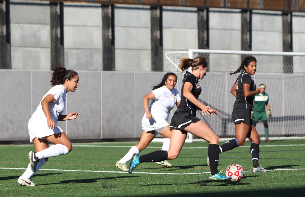  Jesse Bareilles #8 (l), takes control of the ball with assist from Marianna Aguirre #11 (r), against Hartnell College of Salinas. The Rams go on to win the match 5-1 on Friday. Oct. 2, 2015 at CCSF. (Photo by Franchon Smith/The Guardsman)