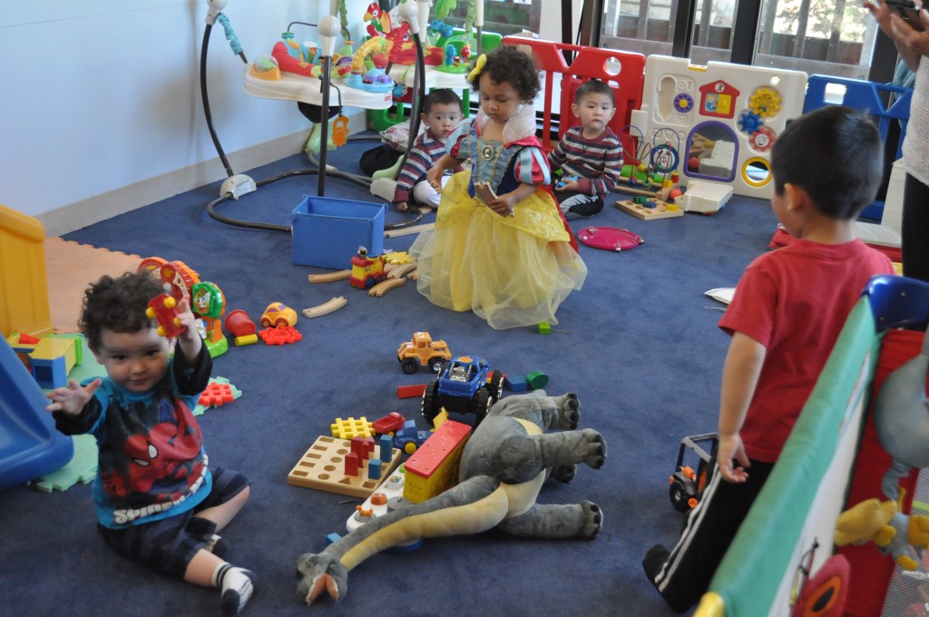 Children dressed in costumes play in the Family Resource Center on Ocean campus after trick-or-treating.