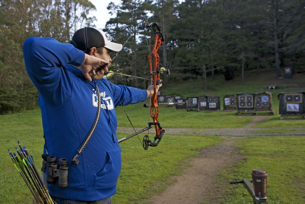 Rudy Sandoval Jr. aims for the target at the San Francisco Archery Range in Pacifica on March 25, 2016. (Photo by Cassie Ordonio/ The Guardsman)