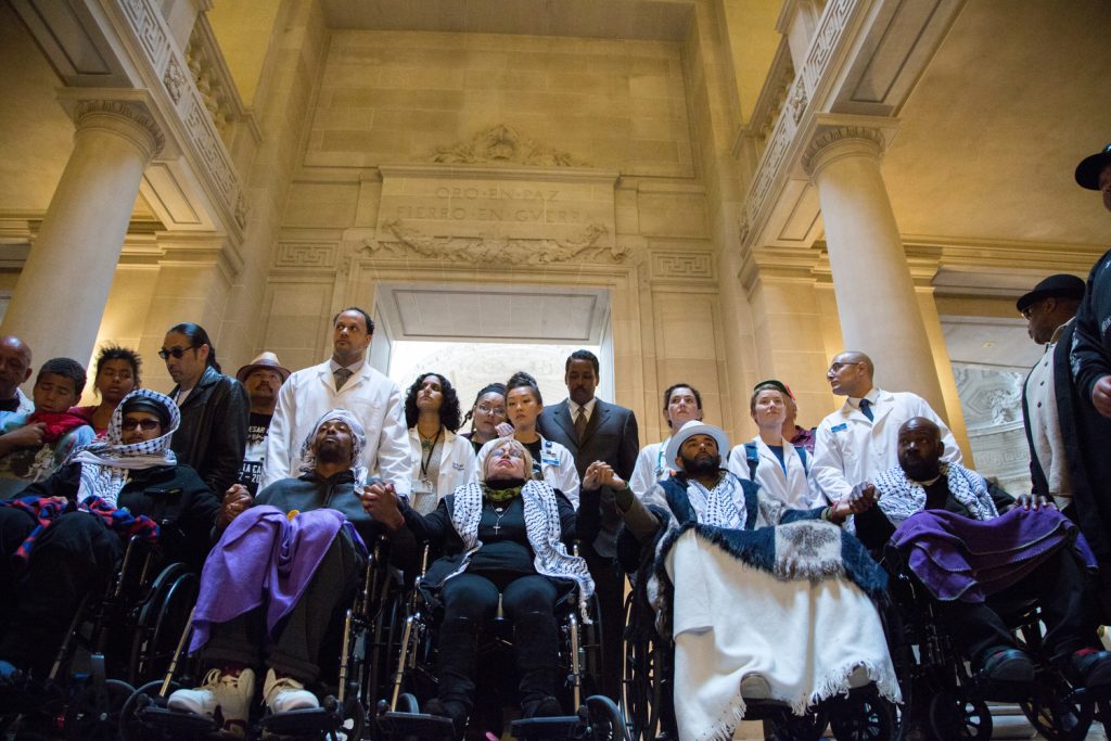 The "Frisco 5" hunger strikers (from left in wheelchairs) Ilych Sato, Sellassie Blackwell, Maria Cristina Gutierrez, age 66, Edwin Lindo and Ike Pinkston take a moment at City Hall before demanding to meet with Mayor Ed Lee in protest against alleged police brutality. (Santiago Mejia / The Guardsman) 