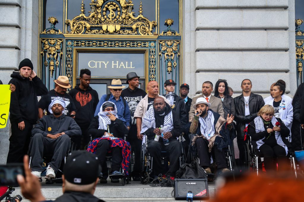 (From L to R ) Sellassie, Equipto, Pinkston, Lindo, and Gutierrez, also known as the 'Frisco Five' hold a meeting in front of City Hall after marching into the building with hundreds of protestors, rallying against police brutality on Tues. May 3, 2016, (Photo by Natasha Dangond/Special to The Guardsman)
