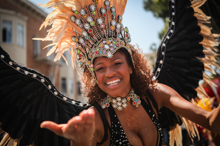 Carnaval performer in costume marches in the 38th Annual Carnaval San Francisco grand parade on 24th Street in San Francisco's Mission District during Memorial Day weekend, Sunday, May 29, 2016. (Photo by Ekevara Kitpowsong)