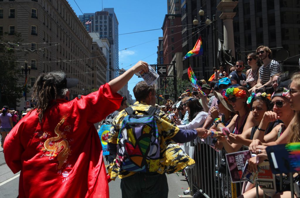 City College faculty hand out flyers to the crowd along the parade route in attempt to recruit future students during the San Francisco Pride Parade on June 26, 2016. (Photo by Cassie Ordonio/The Guardsman)