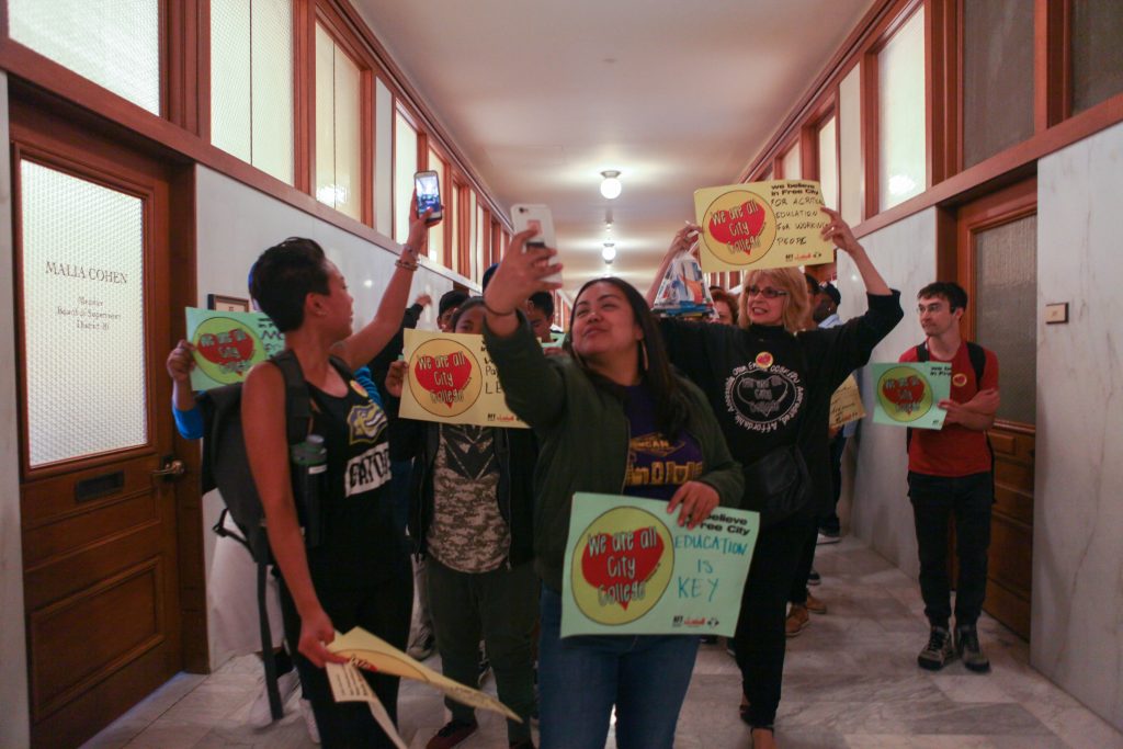 Student supporters Snapchat during their march with AFT members through the Board of Supervisors corridors in San Francisco City Hall on July 12, 2016. 