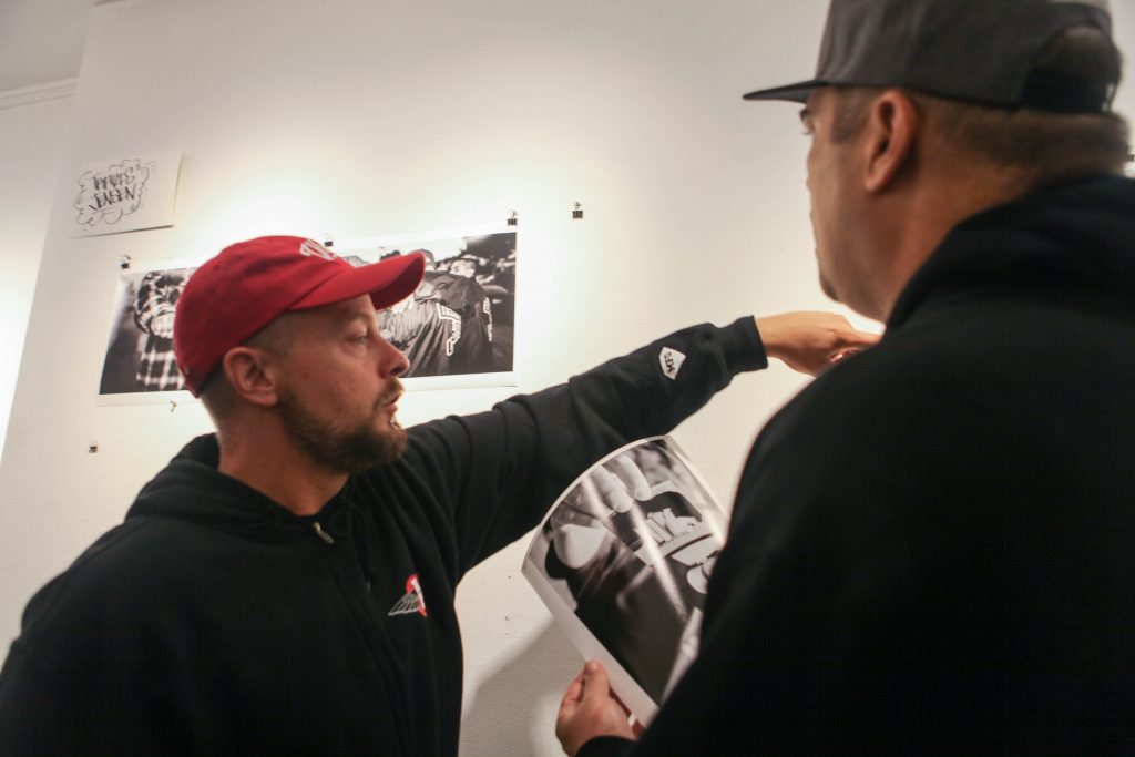 Photographer Travis Jensen promotes his artwork at Book and job Art Gallery on Aug. 5, 2016 (Photo by Cassie Ordonio/The Guardsman)
