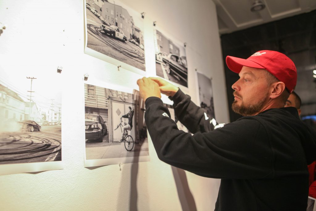Travis Jensen gives away photographs to his supports at Book and Job gallery on Aug. 5, 2016 (Photo by Cassie Ordonio/The Guardsman)