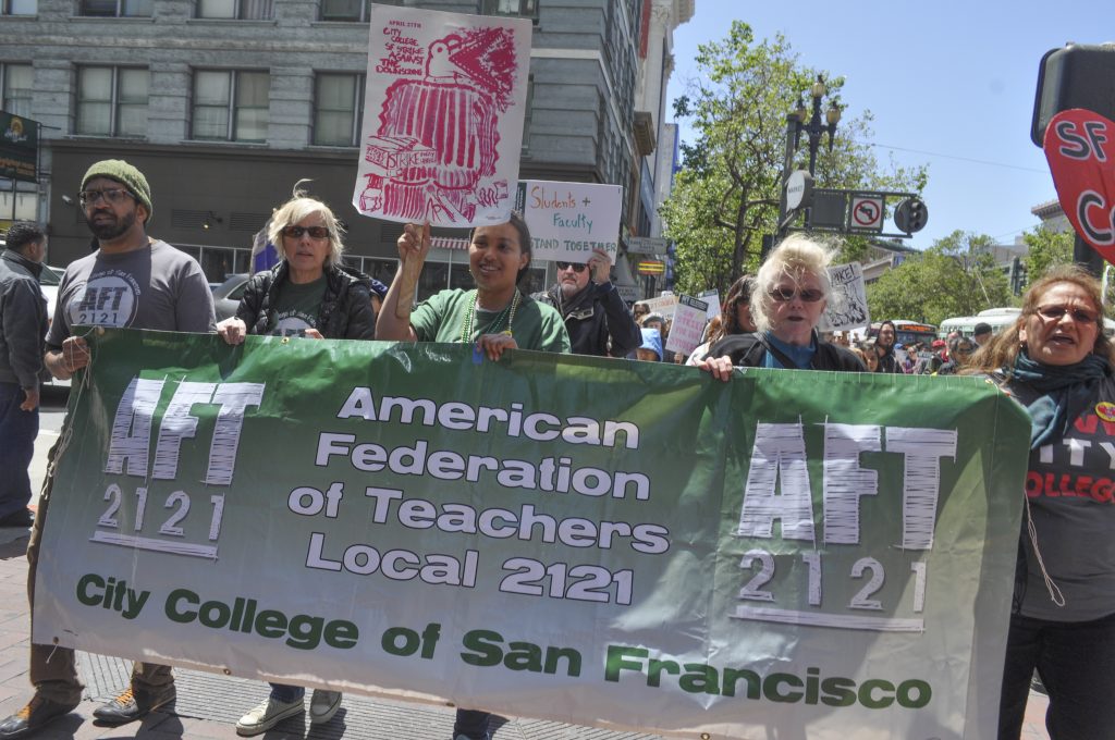 AFT members, teachers, students and protesters marching down Market Street towards the Civic Center campus of City College of San Francisco as part of the strike on April 27, 2016. (Photo by Bridgid Skiba/The Guardsman)