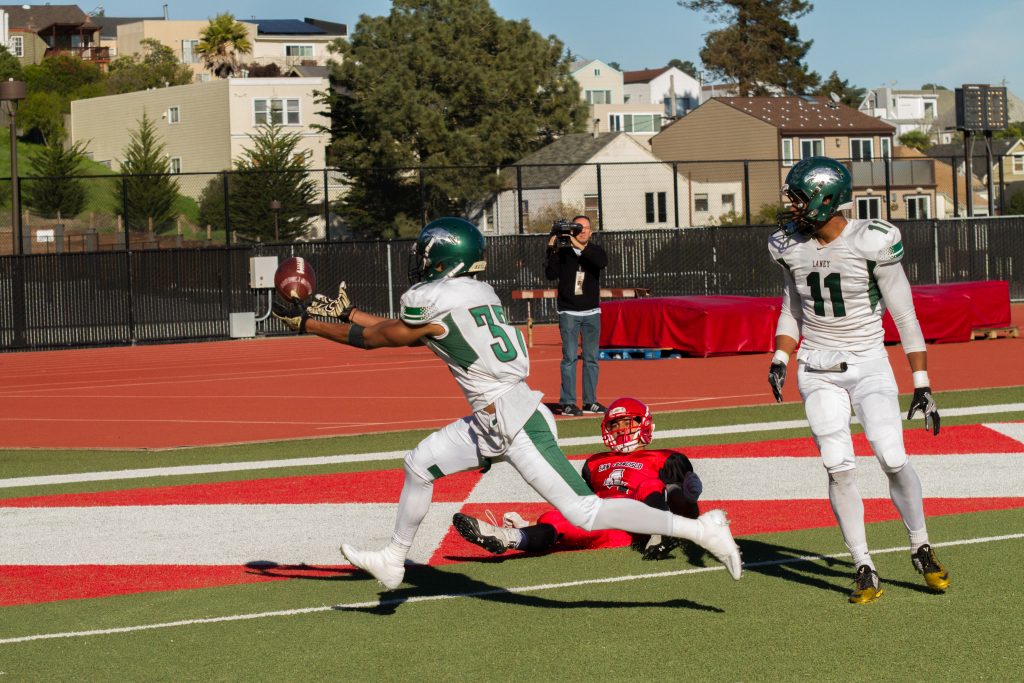 Laney's Ke'Nigil Williams, 37,i (left) intercepts a bobbled pass that was intended for Erik Phillip, 4 (center)  during  the San Francisco Community College Bowl at George Rush Staduim on Saturday Deember 3, 2016. Photo by Franchon Smith/The Guardsman