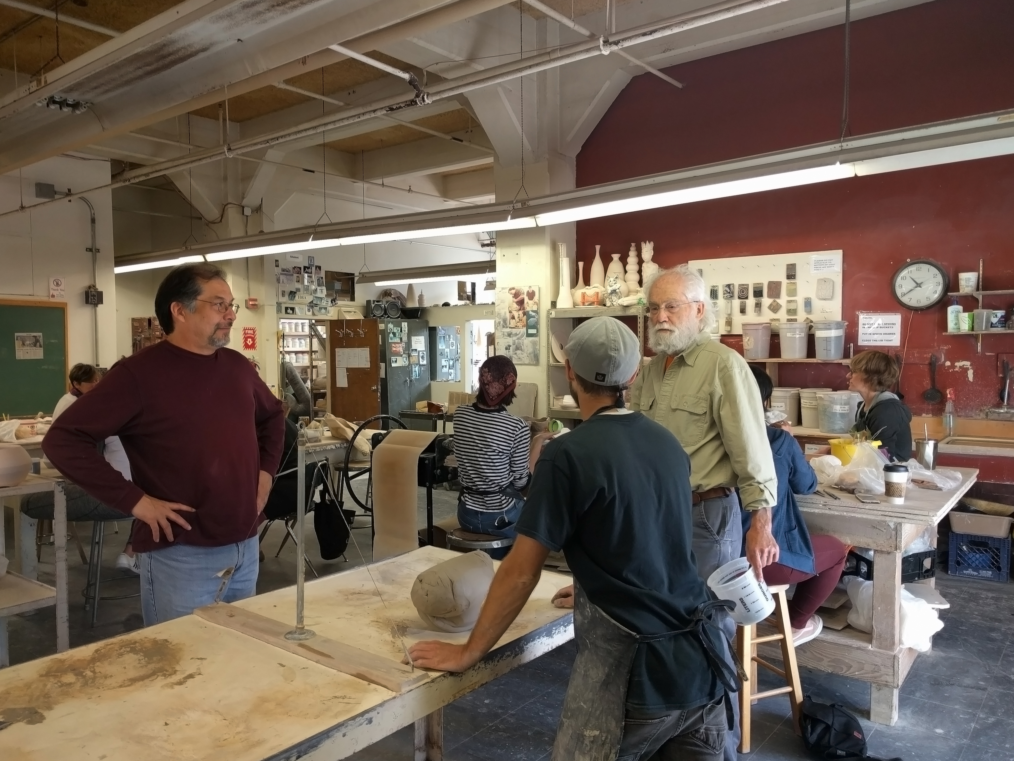 Instructor Olivero Quezada and his assistants instruct students in the spacious Fort Mason ceramics studio. Photo by Elena Stuart/The Guardsman 