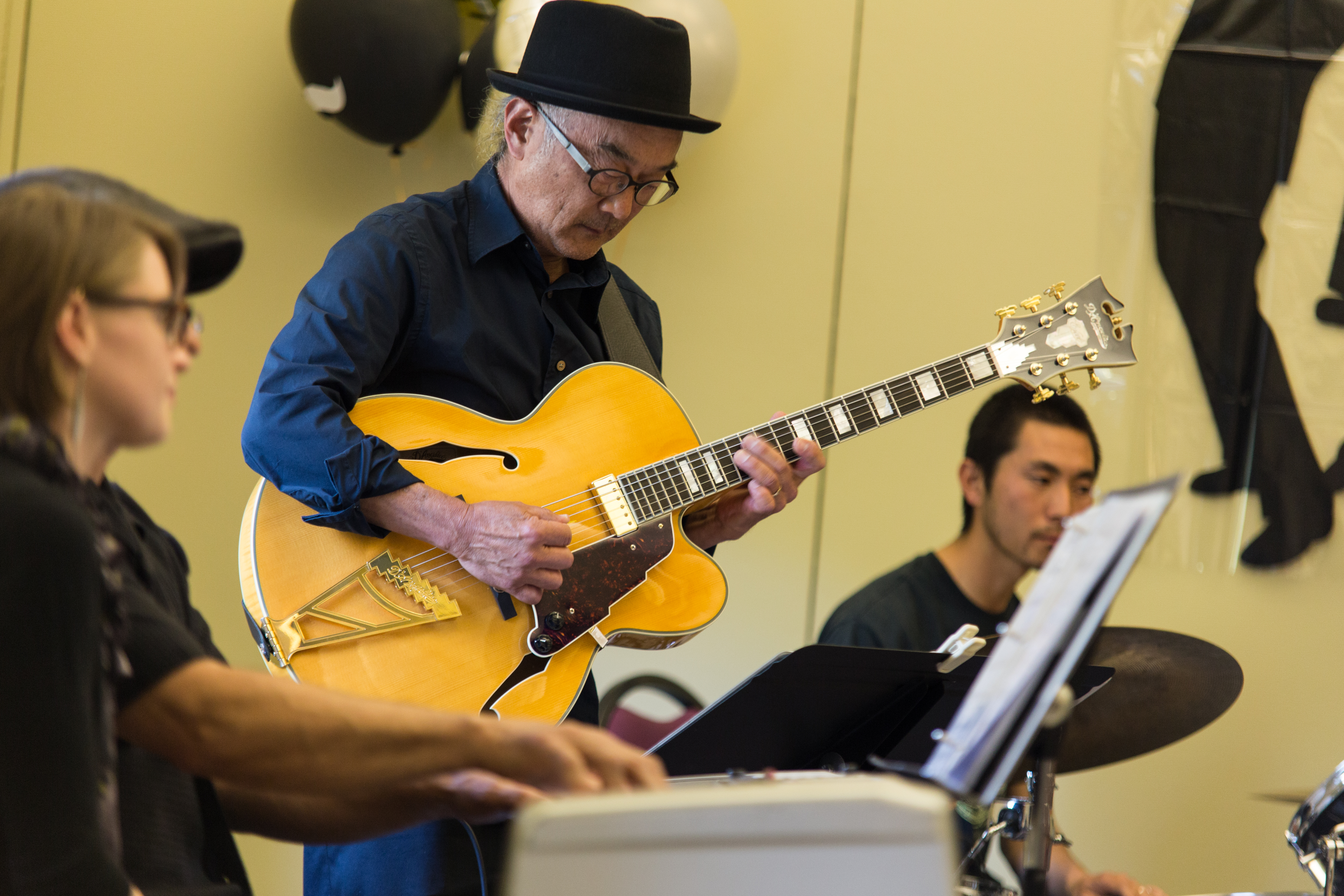 Katsumi Asazawa, center, plays a guitar solo during the band’s performance of “Saint Louis Blues” by W.C. Blues in the Pierre Coste Room on Apr. 13, 2017. Photo by John Ortilla/The Guardsman. 