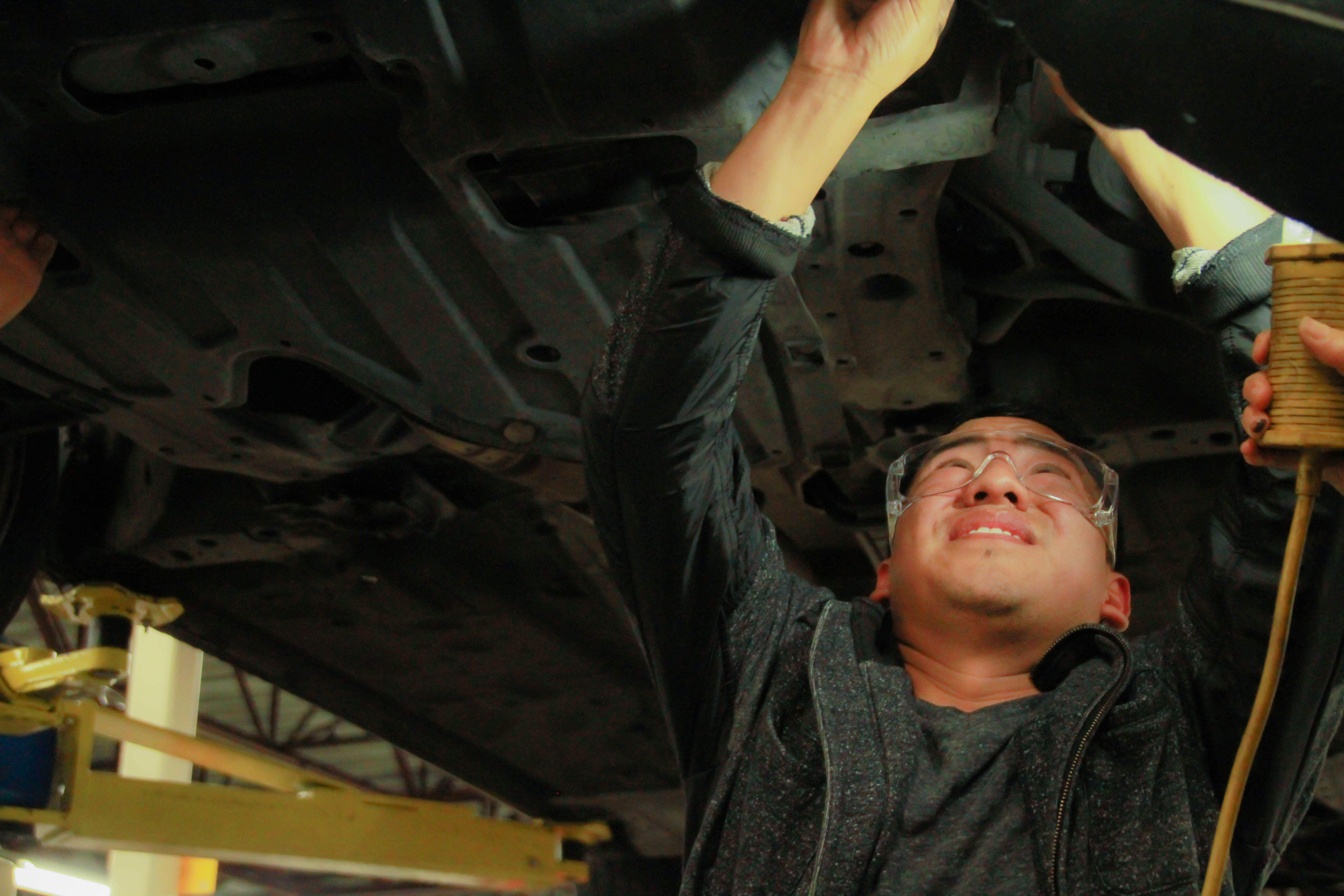  Byron Mejia, 28, works on his car at the City College Evans Campus during an automotive course that teaches students basic auto maintenance. Photo by Karen A Sanchez/The Guardsman 