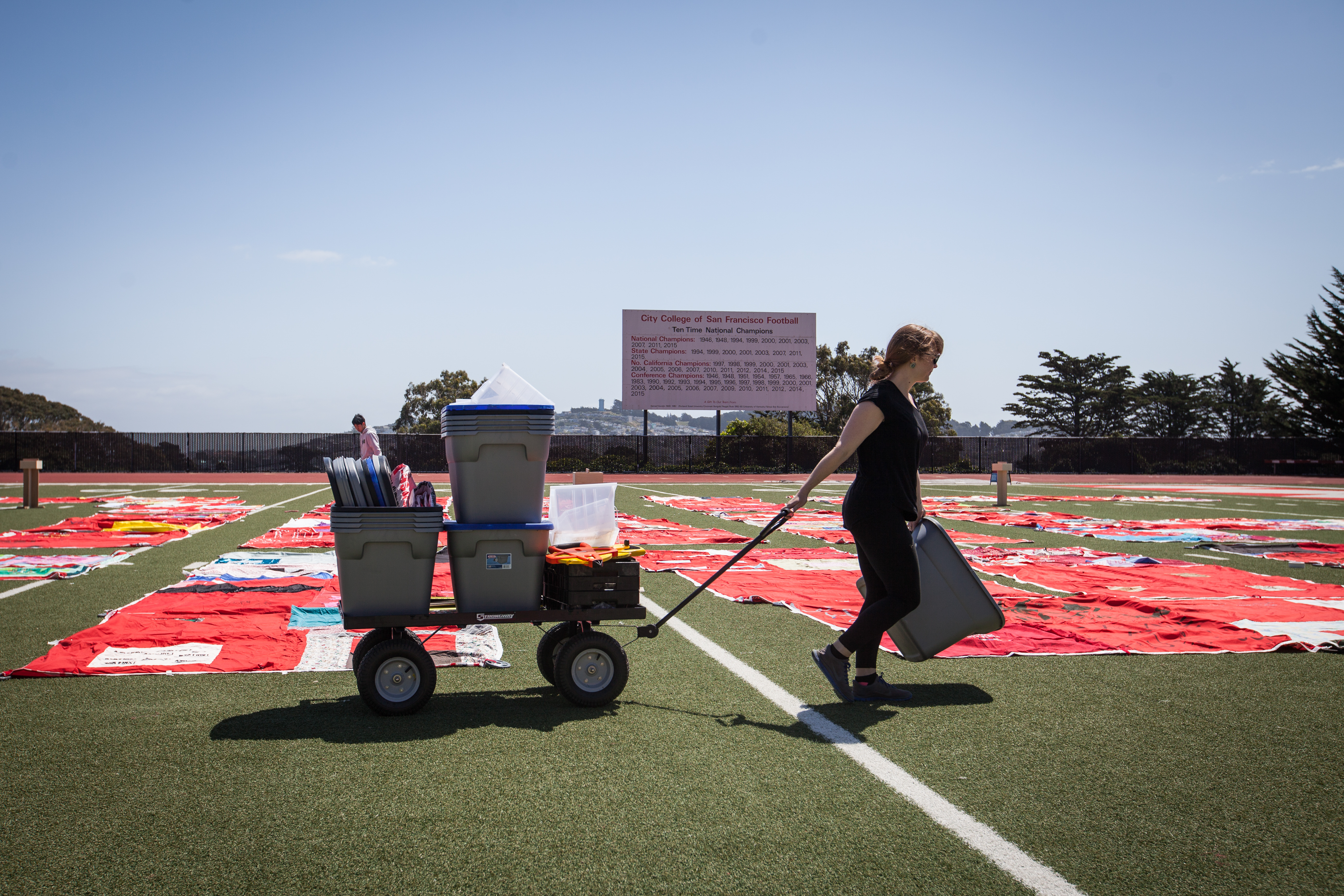 Co-Founder of FORCE: Upsetting Rape Culture Hannah Brancato helps set up during the installation of The Monument Quilt on the football field of George M. Rush Stadium at City College of San Francisco Ocean Campus on Saturday, May 6, 2017. (Photo by Ekevara Kitpowsong)