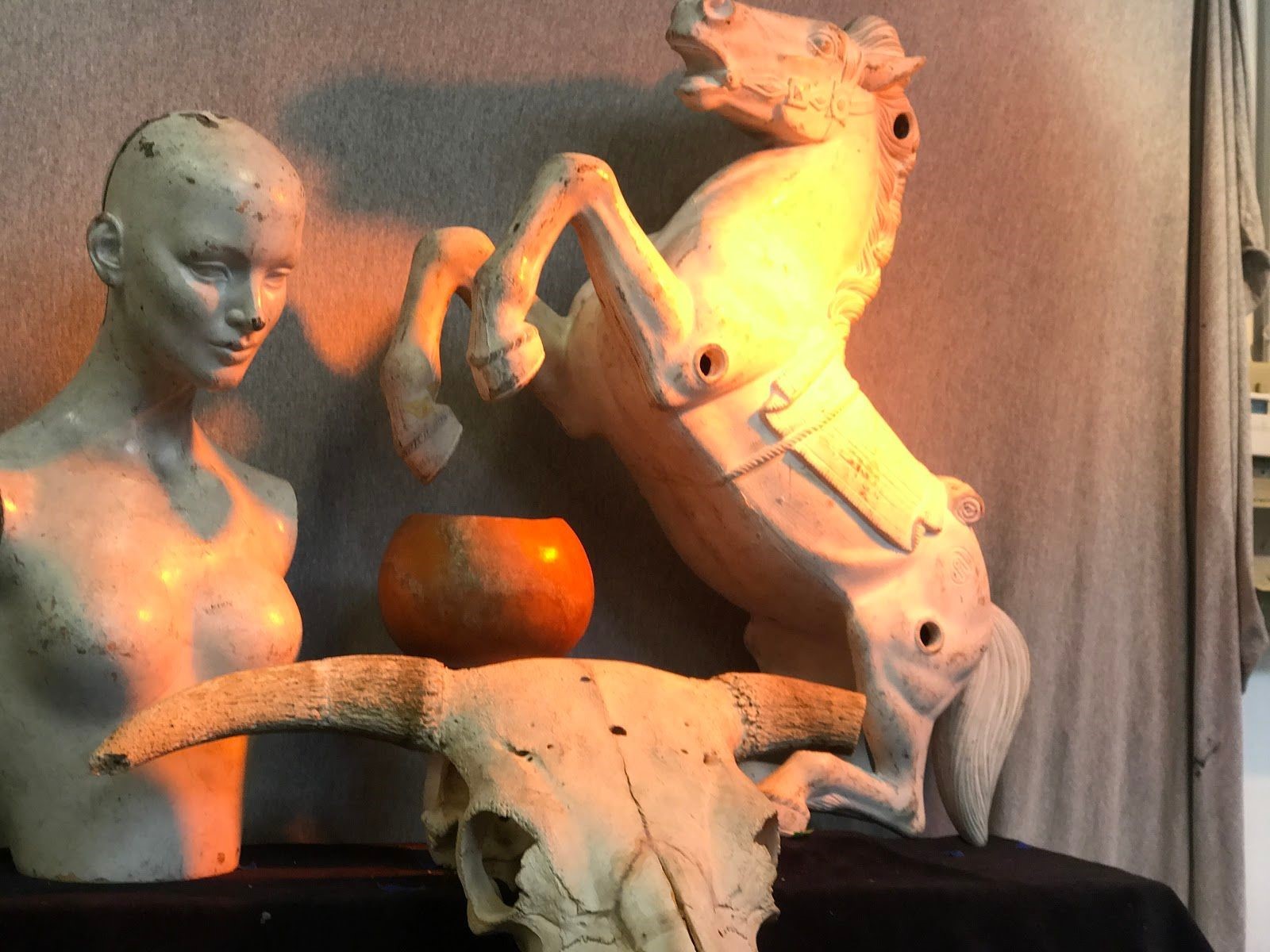 These figures were used for beginning art students to paint. An orange light is positioned overhead to give off a sunset vibe. Photo taken on Sep. ?, 2017 by Jasmine. 