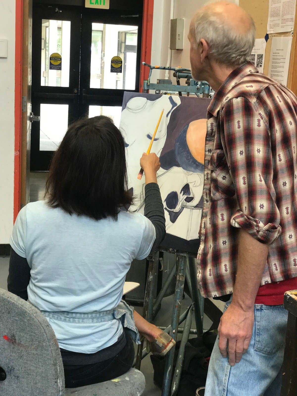 The instructor, Andrew Leone, is guiding a student and helping her pick the best colors to use. Photo taken on Sep. ?, 2017 by Jasmine 