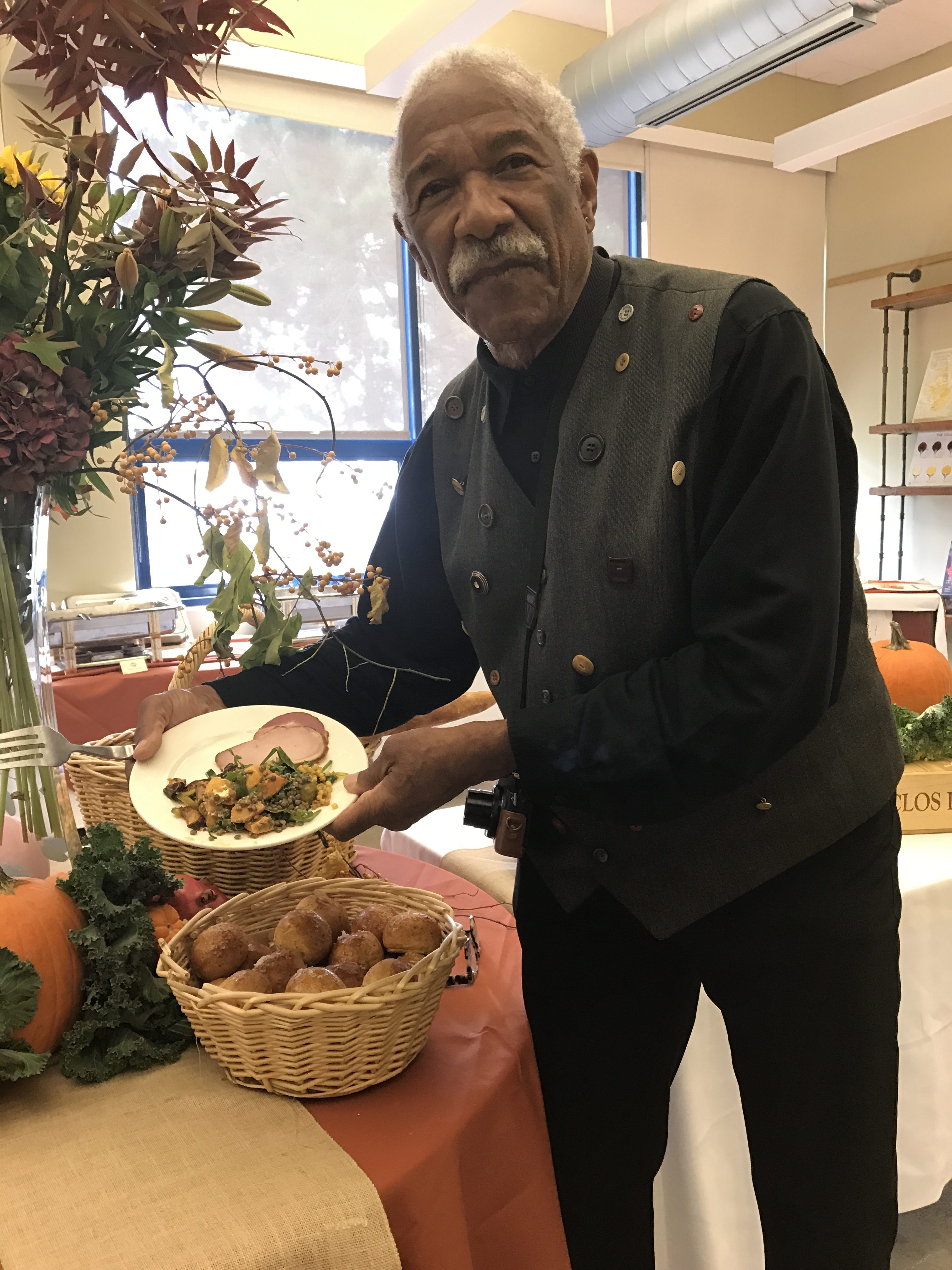 A Fall Harvest Festival attendee enjoys a plate of Autumn food on Wednesday, Oct. 18, 2017. Photo by Diane Carter. 